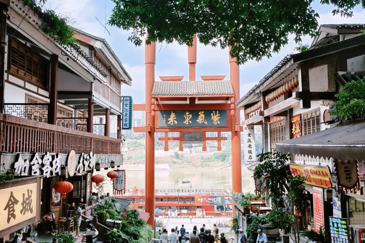 Visitors walking through the traditional entrance gate of Ciqikou Ancient Town
