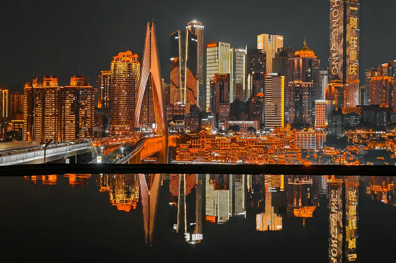 Hongya Cave and Qiansimen Bridge reflected in the Jialing River at night